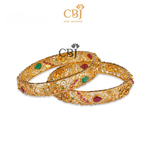 A CZ pachi designer bangle featuring ruby and emerald stones.