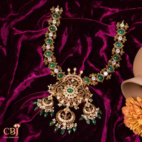 Elegance in every step, grace in every move. This haram with CZ, pearls, and emeralds is the perfect accessory to make a statement.