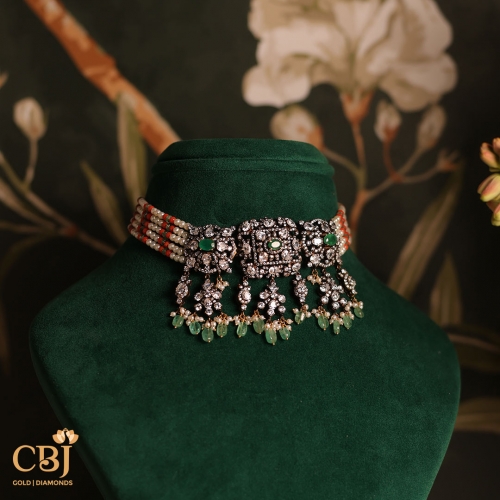 Step into a world of exquisite craftsmanship with our stunning Victorian beaded choker, featuring emeralds, CZs, and coral stones.