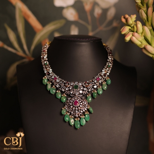 A symbol of grace and femininity – just like the woman who wears it.  Victorian Necklace featuring CZ’s , emeralds and rubies.
