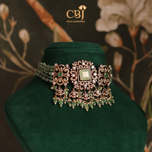 Revel in the glorified elegance of this stunning choker, crafted with intricate beading and delicate CZ and emerald stones.