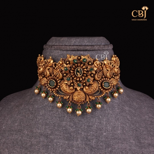 An opulence in design featuring a majestic haram featuring. fine strokes decorated with emerald.