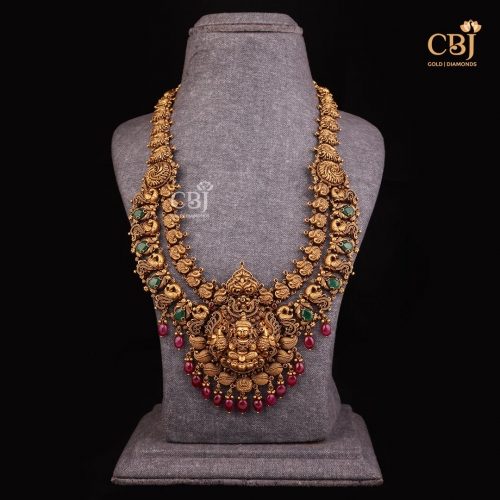 An antique 2 step haram featuring emerald stones in a beaded design.