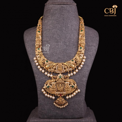A one of a kind Gajalakshmi U-haram studded with cz stones, pearls and emeralds.