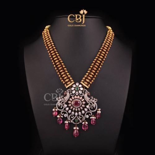 A CZ embossed necklace adorned in beads, rubies and emeralds.