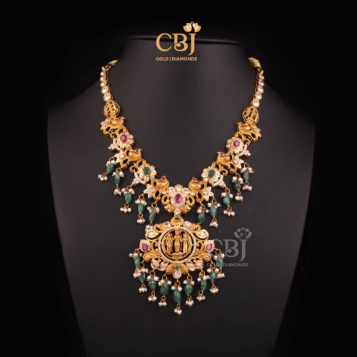 A traditional CZ Pachi Ramparivar necklace featuring rubies, emeralds and pearls.