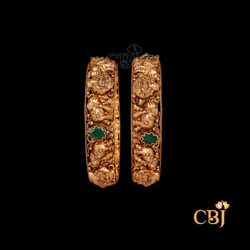 33 grams Nakshi Antique Bangles shown as a pair of gold bangles with ornate Nakshi carving work, antique finish, and smooth circular wrist design.