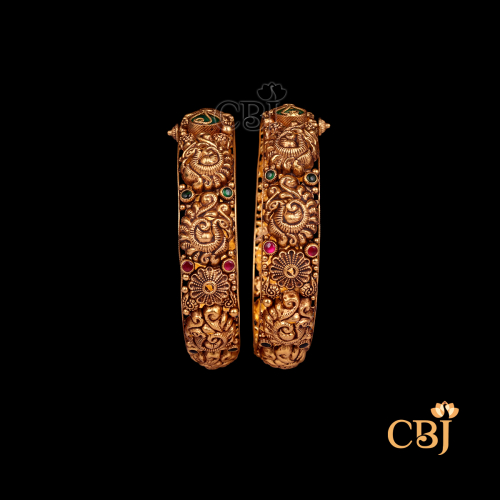 38 grams Nakshi Antique Bangles displayed as a pair of traditional gold bangles with intricate Nakshi carving work, antique finish, and rounded wrist shape.