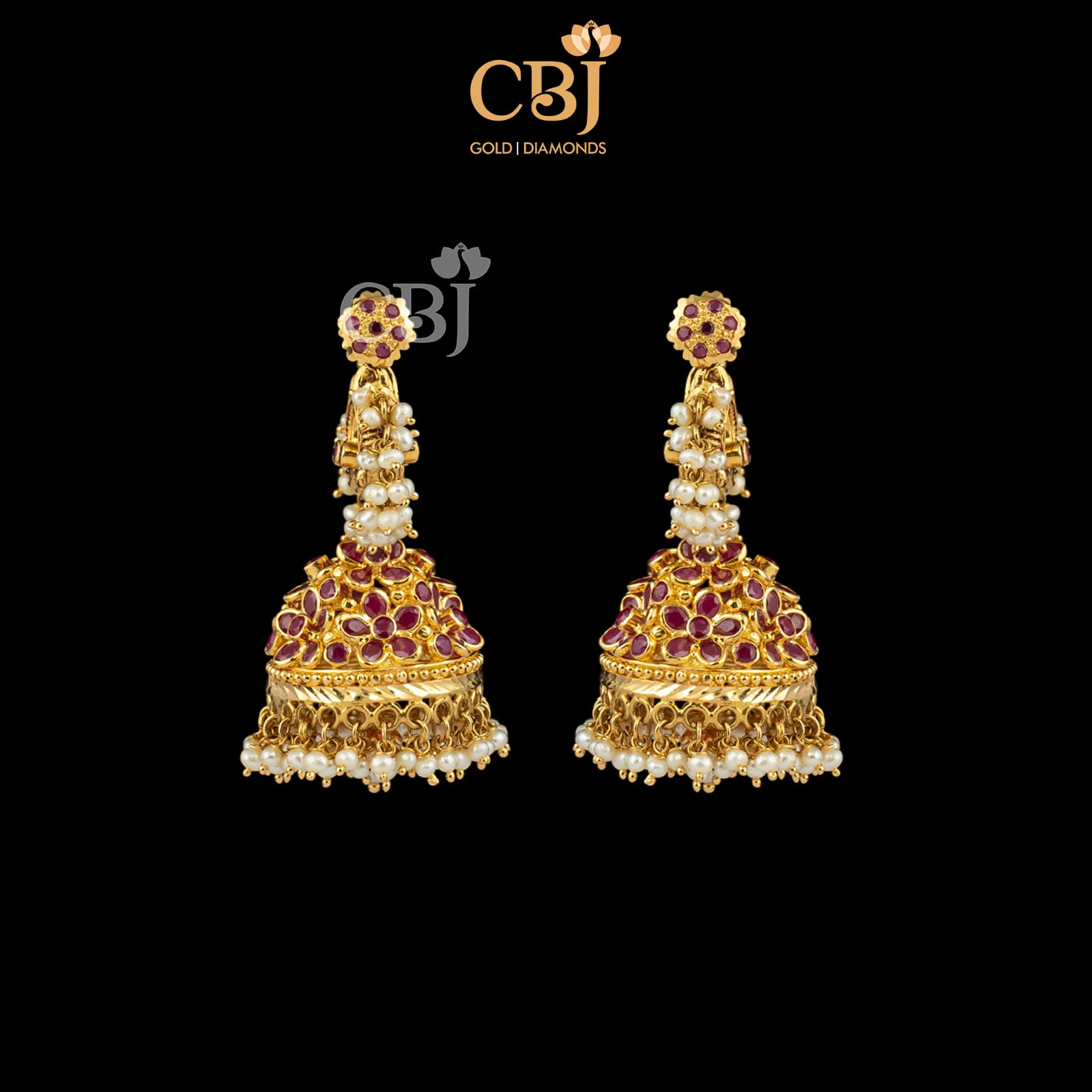 A traditional jhumka featuring pearls and rubies.