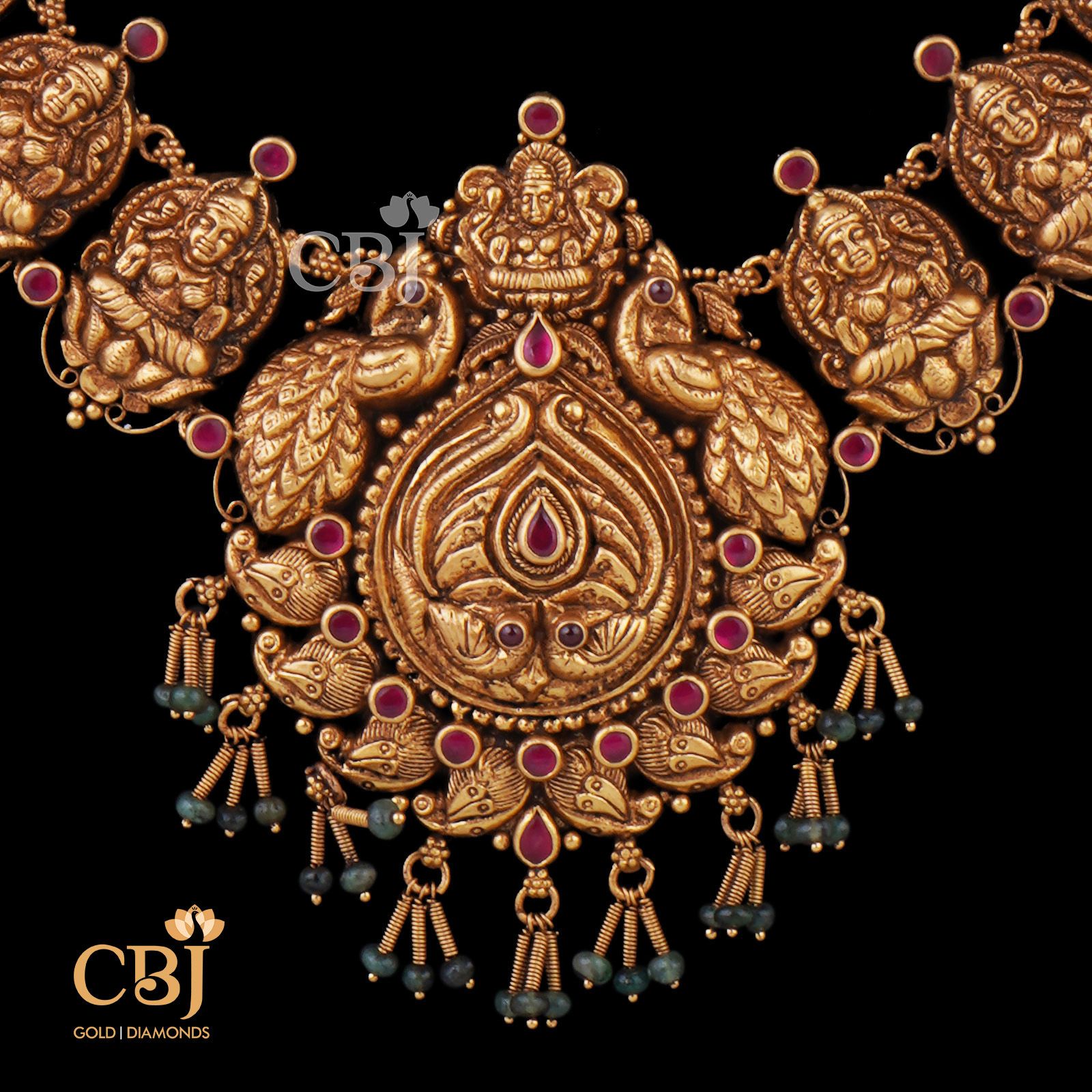 An antique deep nakas/nakashi U haram featuring ruby dots and a peacock design. It is designed to enhance any traditional wear.