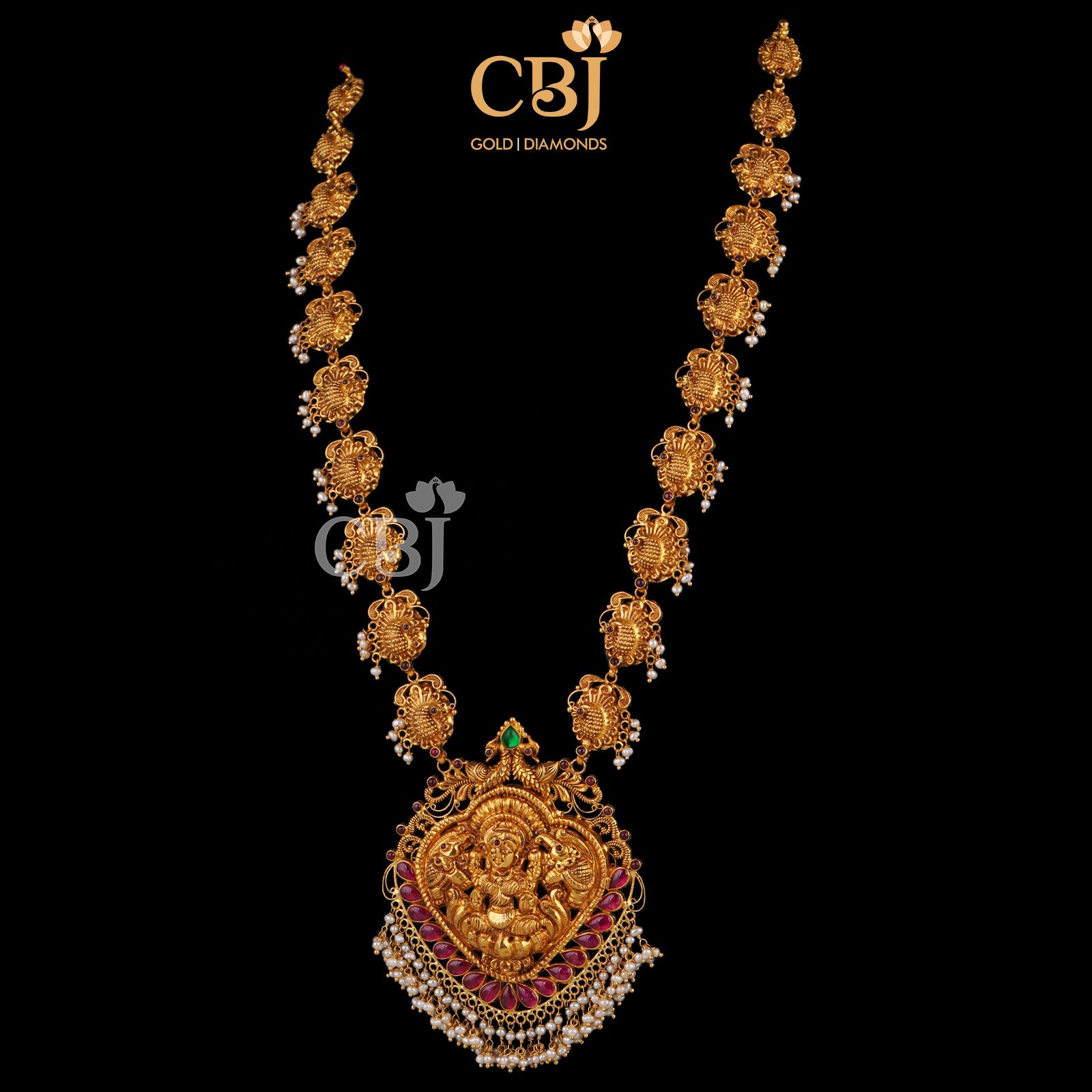 A divine deep nakas work featuring Devi in the centrepiece with suspended micro pearls.