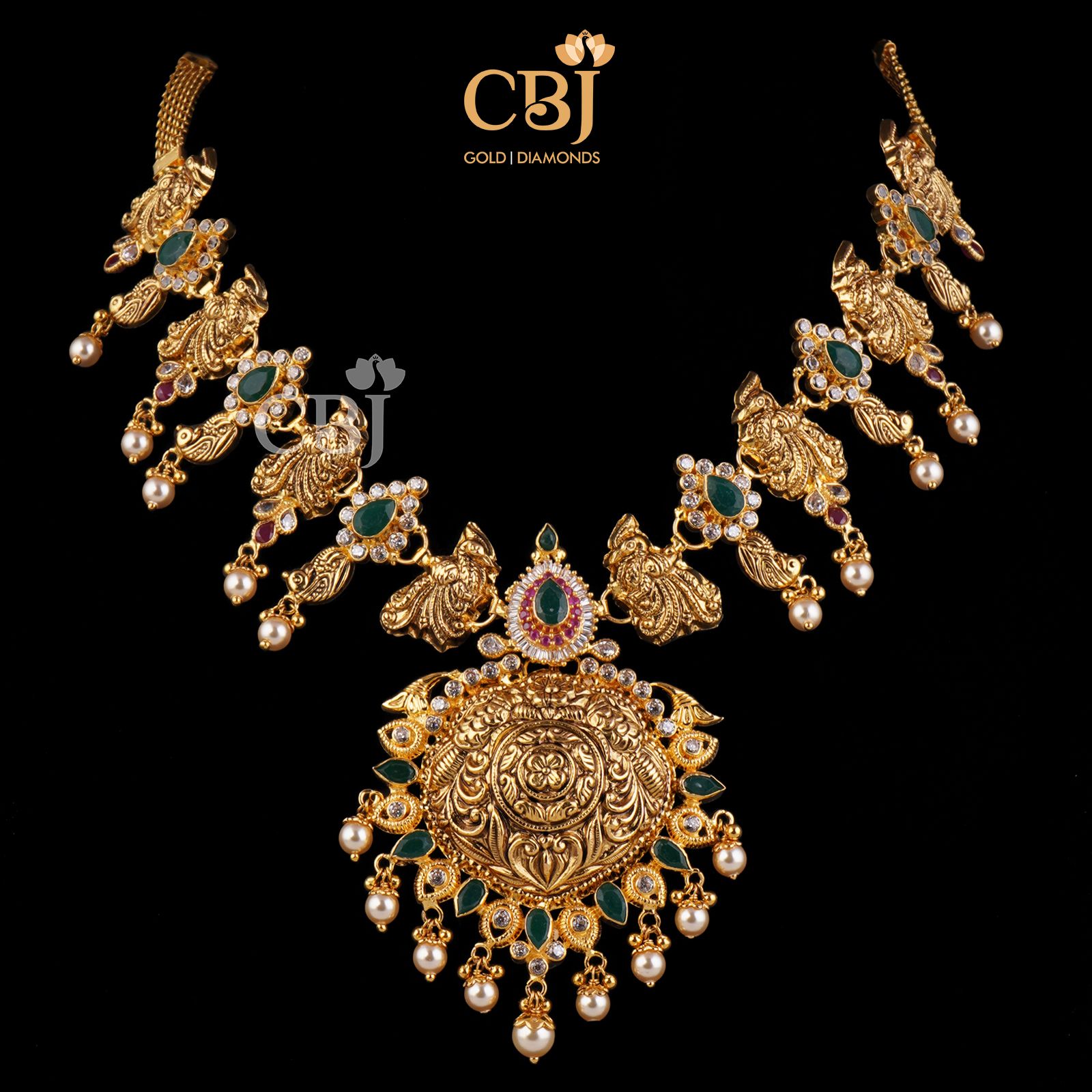 A unique traditional necklace featuring peacock motifs studded with emeralds, suspended with pearls.