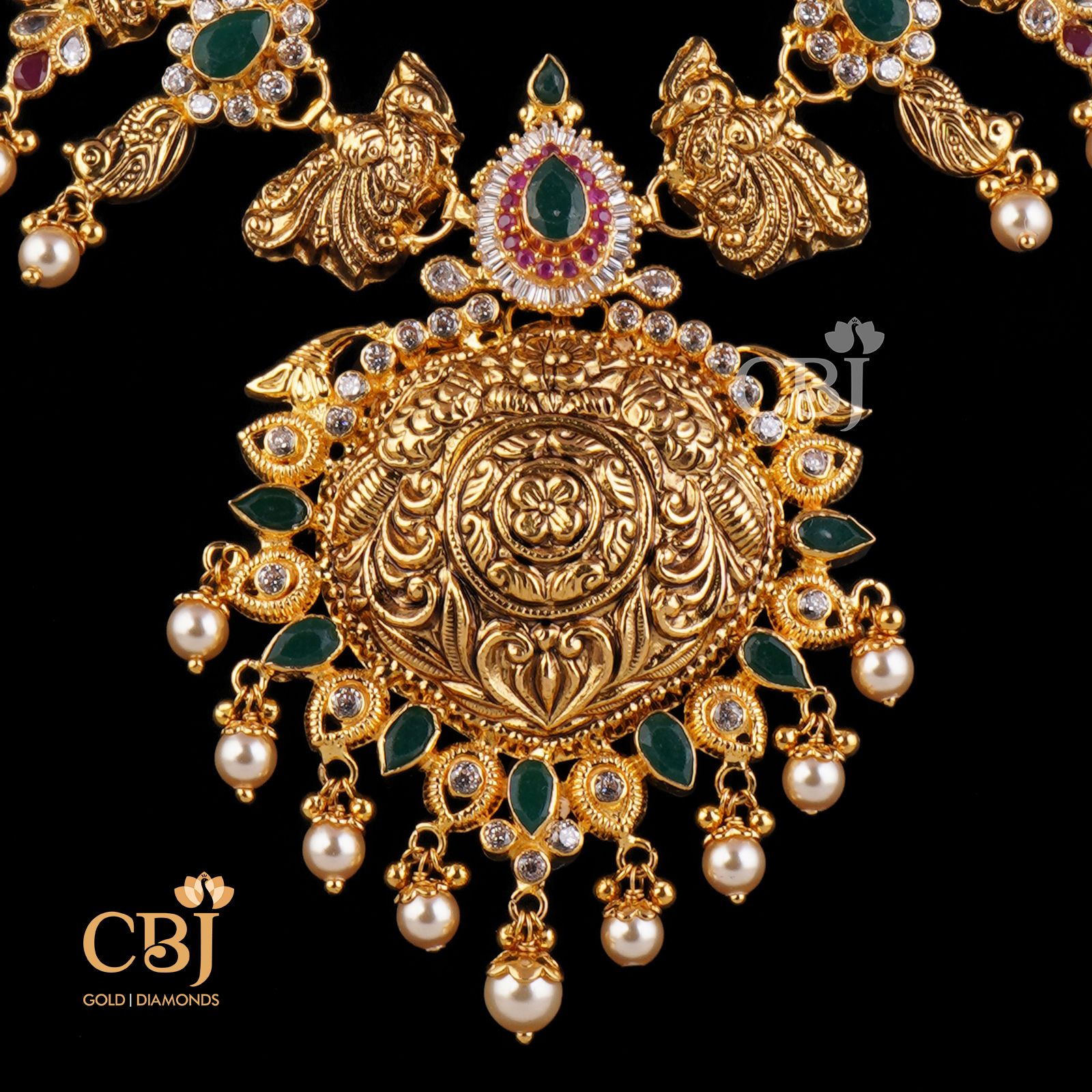 A unique traditional necklace featuring peacock motifs studded with emeralds