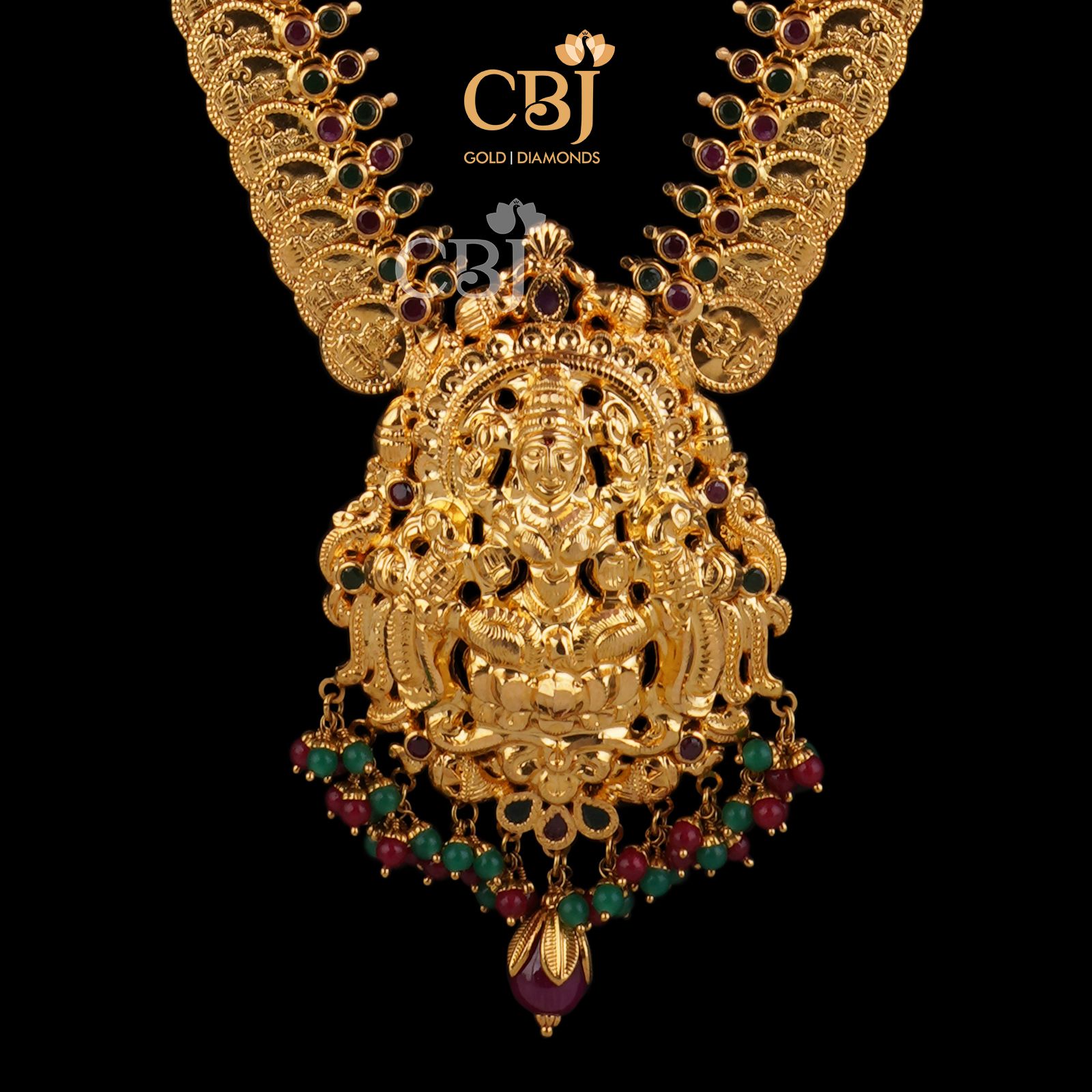 A long Lakshmi kasu haram  studded with rubies and emeralds.