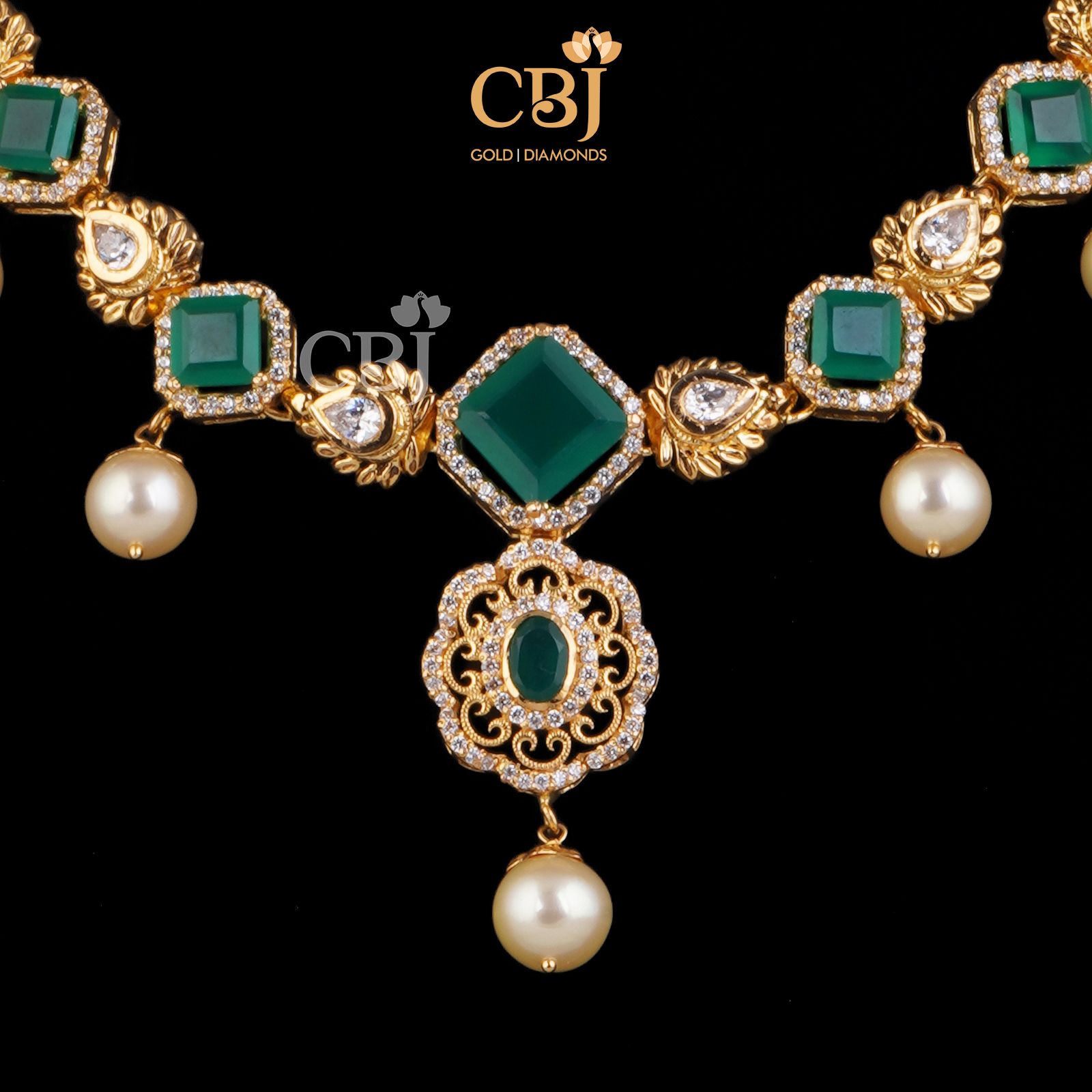 A stunning designer's necklace studded with emeralds and pearls; perfect for your cocktail wear.