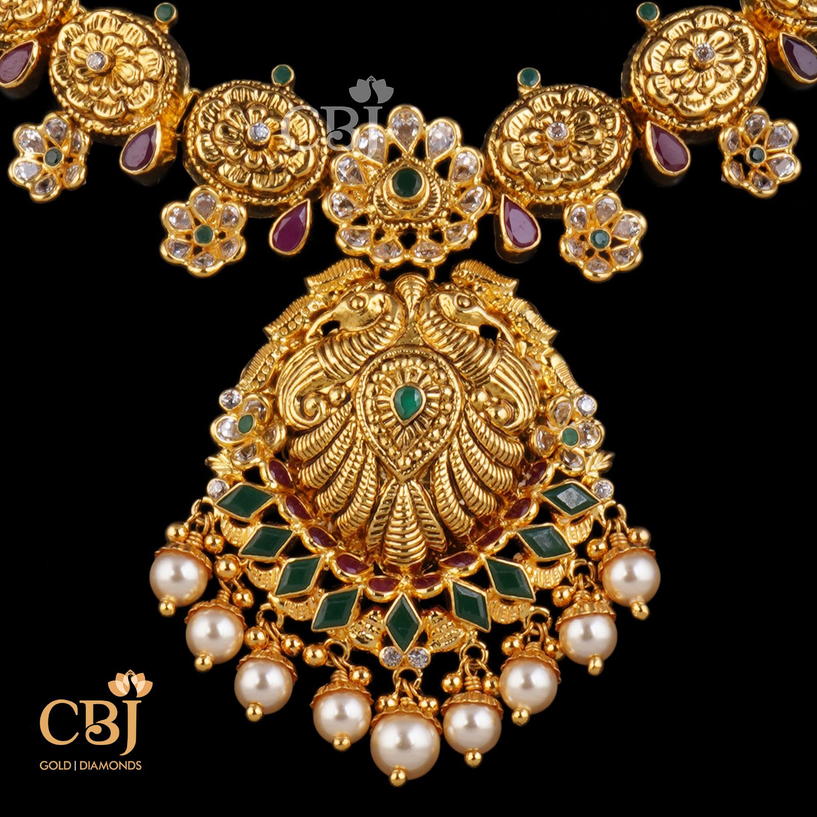 A traditional ethnic mayura necklace with suspended pearls.