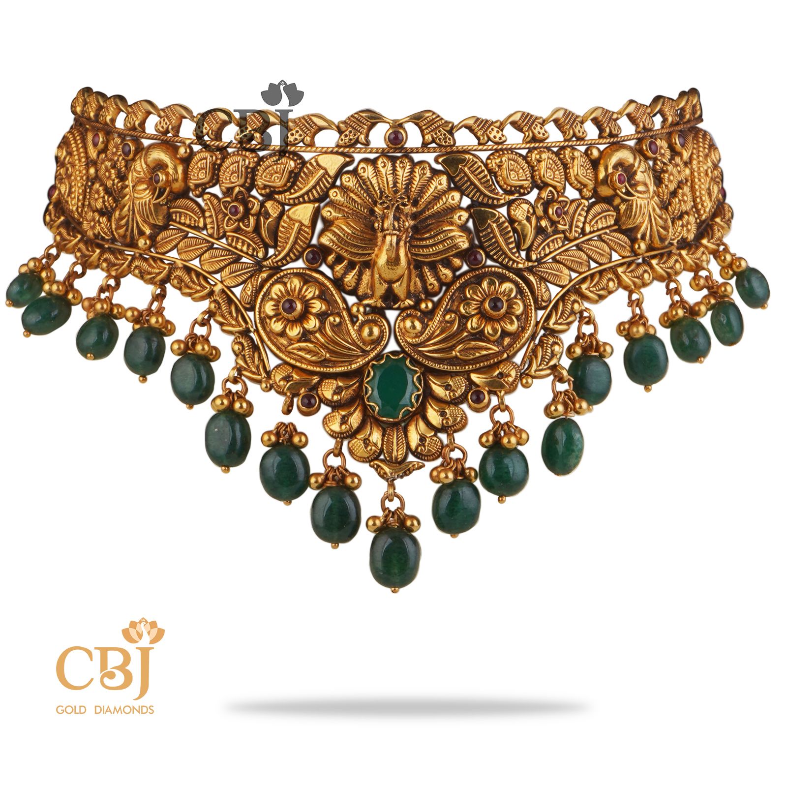 A perfect antique choker that can compliment your grace and elegance. An opulent design with suspended emerald drops.  Mayura Nakashi Choker with Emerald Drops.