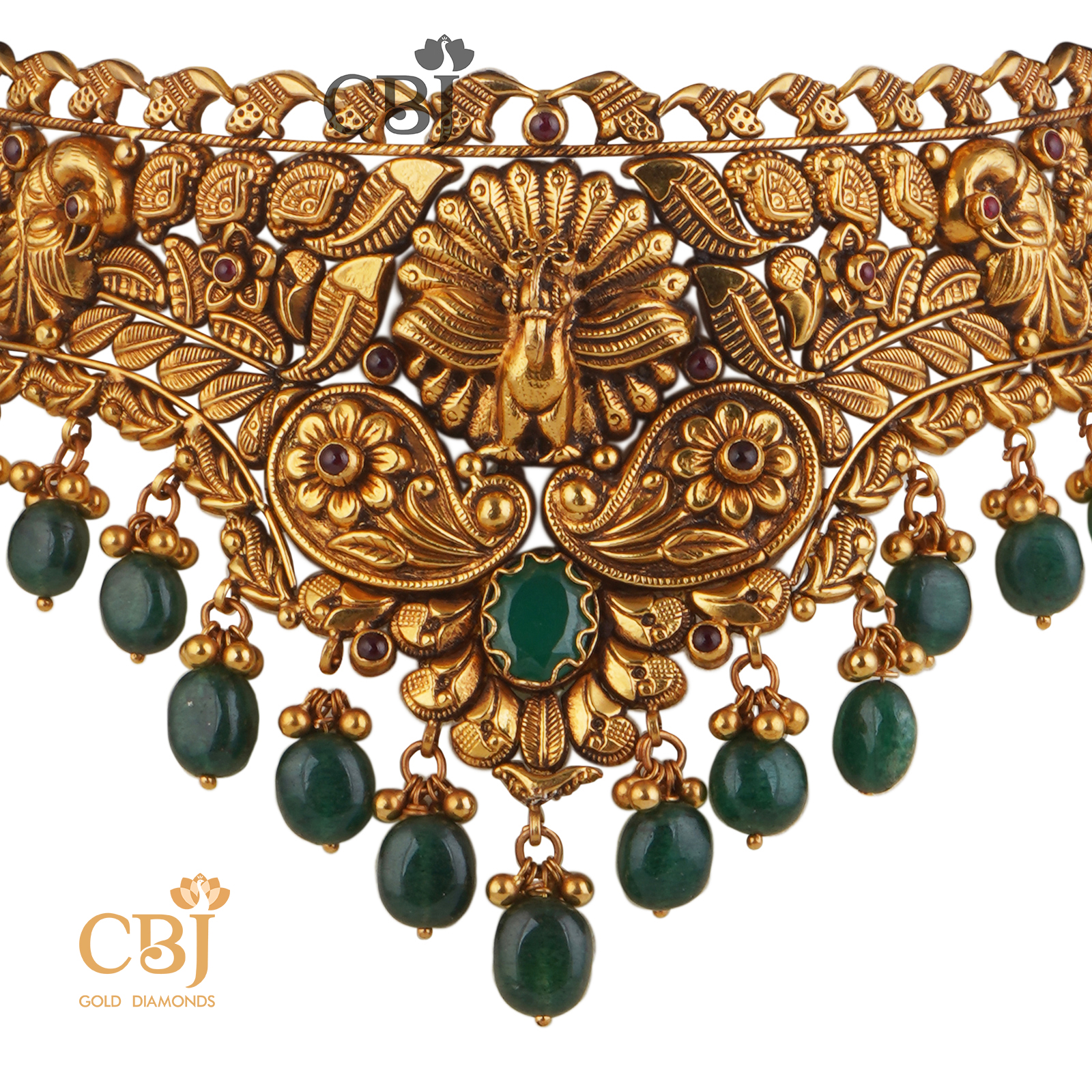 A perfect antique choker that can compliment your grace and elegance. An opulent design with suspended emerald drops.  Mayura Nakashi Choker with Emerald Drops.