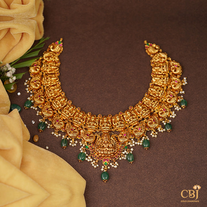 Pure 22k hold complimented by deep green hues. Nakashi necklace with Zambian emerald drops.