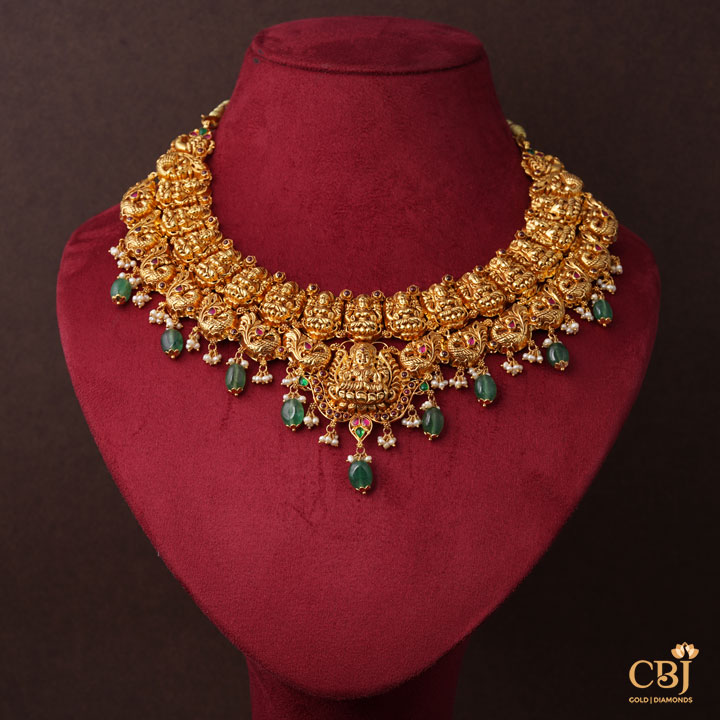 Pure 22k hold complimented by deep green hues. Nakashi necklace with Zambian emerald drops.
