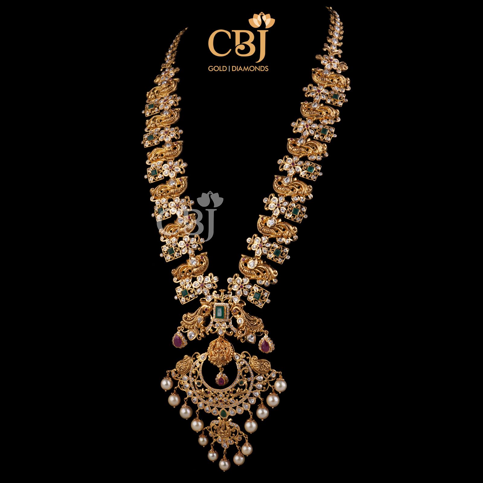 A long CZ pachi haram featuring a peacock design studded with rubies and emeralds.