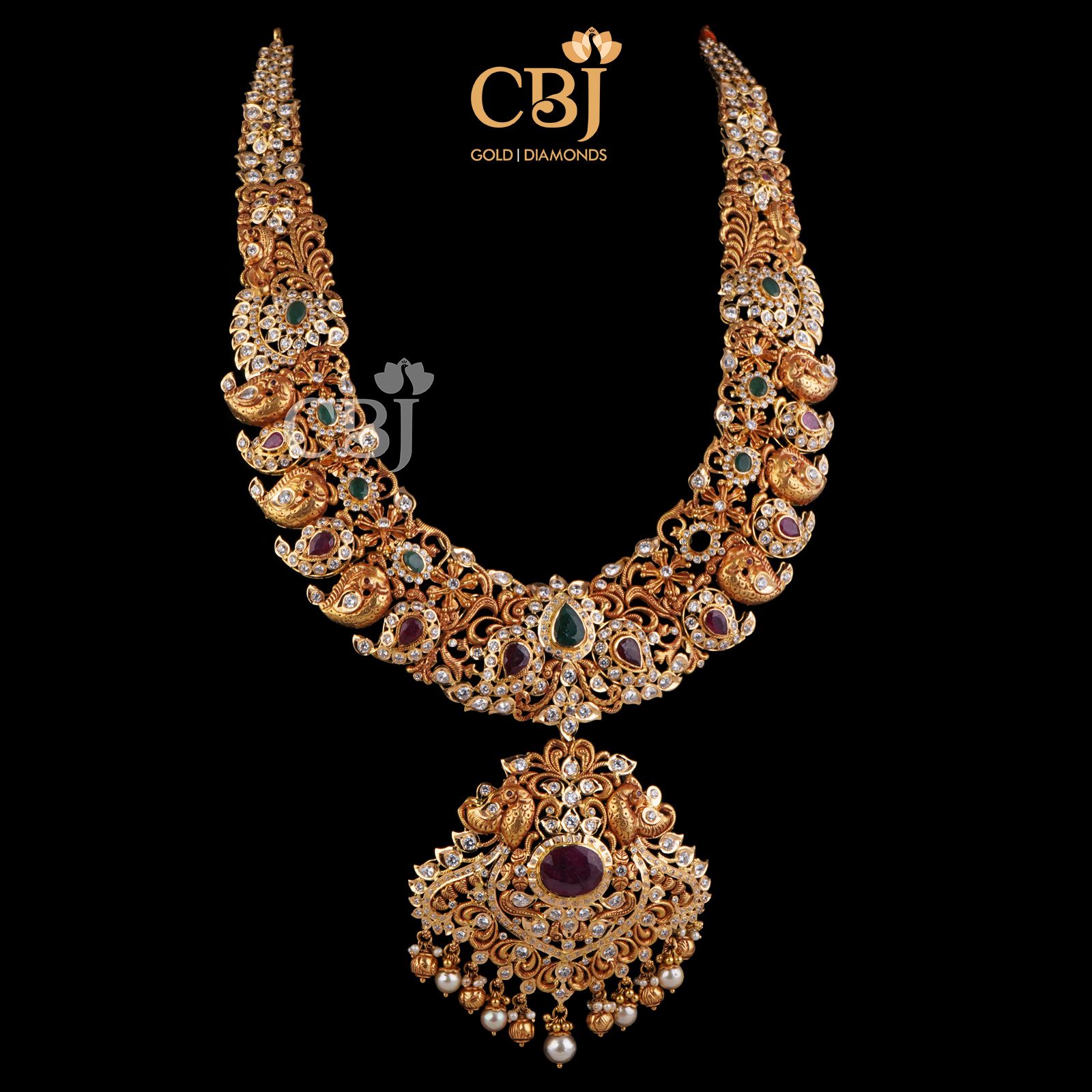 An amazing bridal designer U haram with mango motifs featuring ruby and CZ stones.