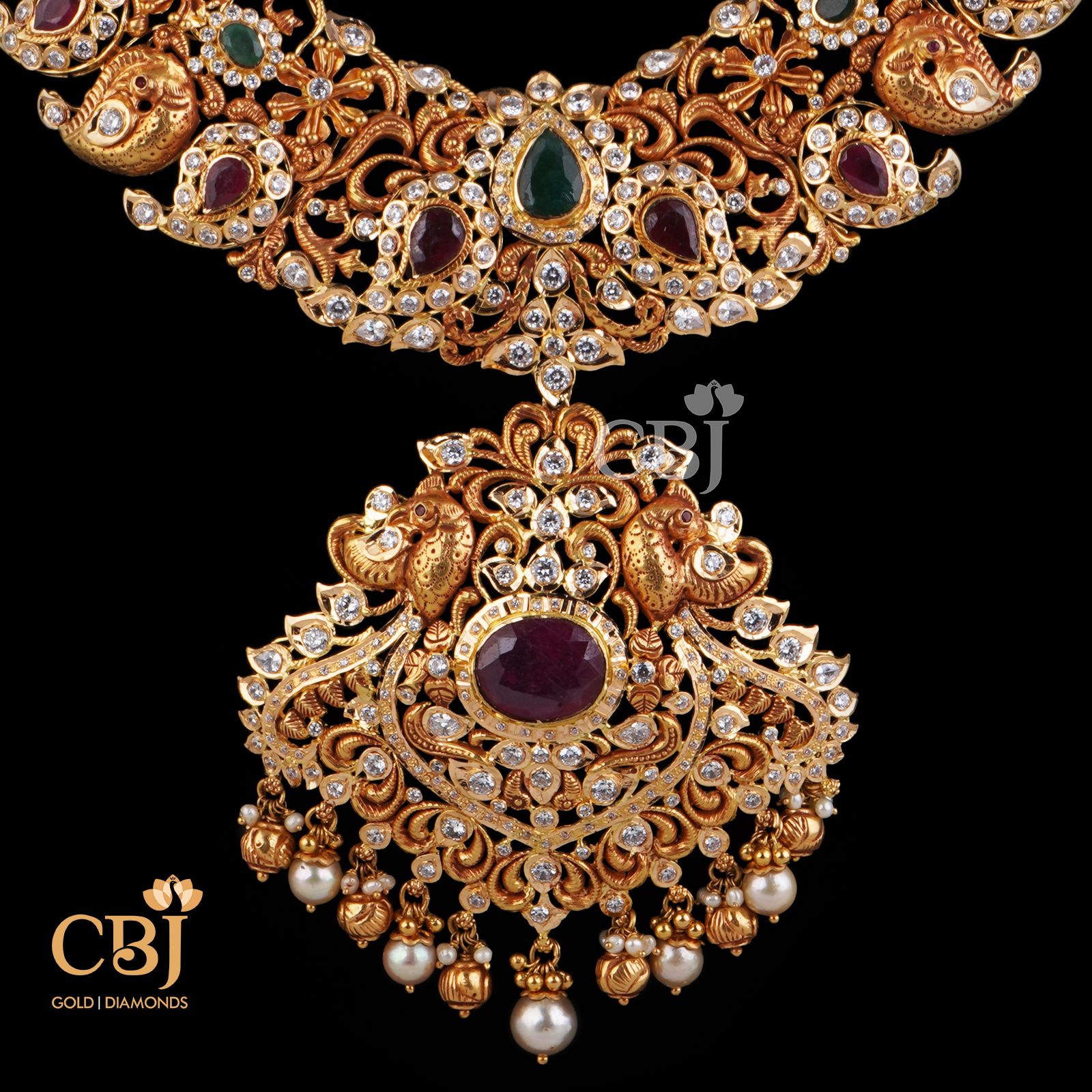 An amazing bridal designer U haram with mango motifs featuring ruby and CZ stones.