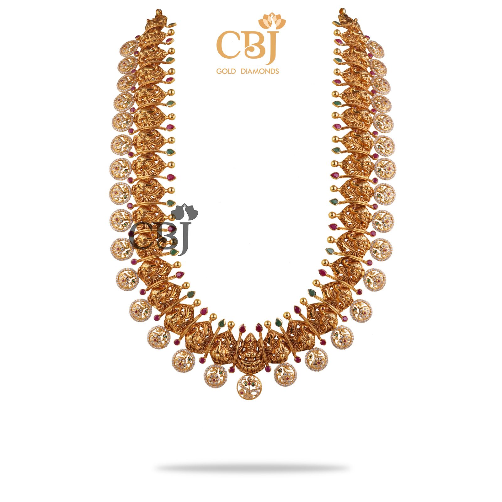 A classic 22k gold bottumala bejewelled with ruby and emerald dots in a CZ pachi design.