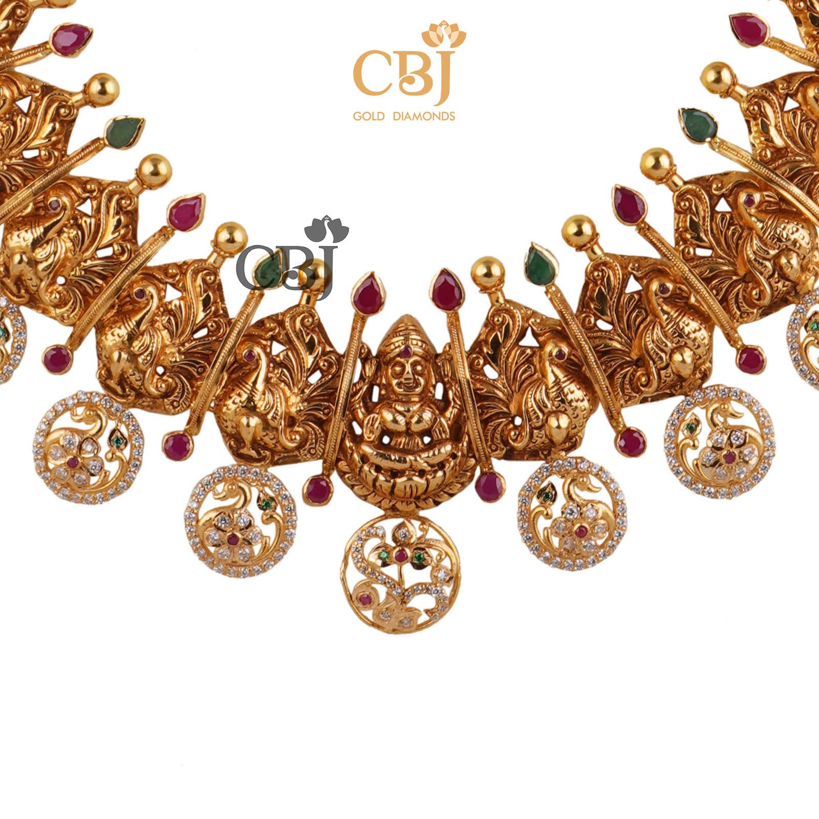 A classic 22k gold bottumala bejewelled with ruby and emerald dots in a CZ pachi design.