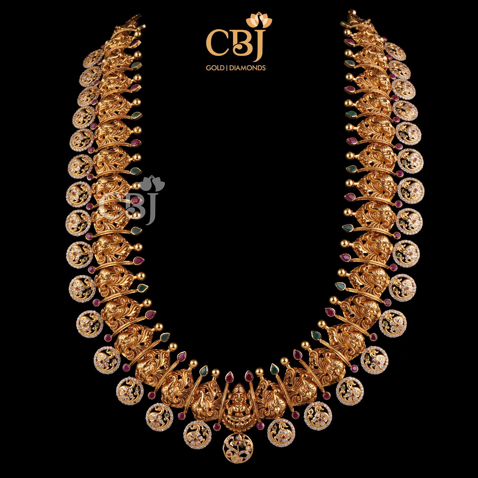 A classic 22k gold bottumala bejewelled with ruby and emerald dots in a CZ pachi design.