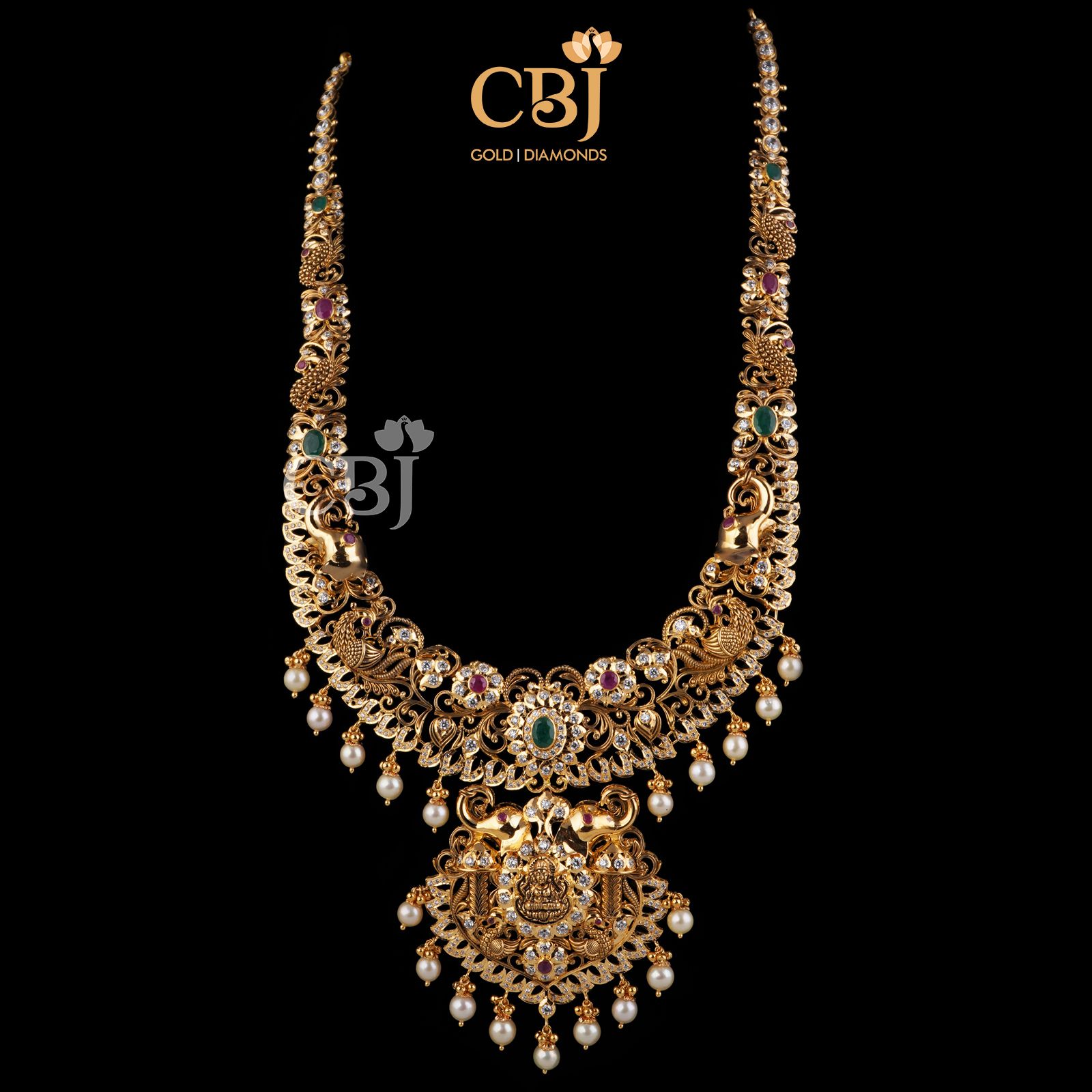 A classic CZ pachi U haram featuring rubies, emeralds and suspended pearls. 