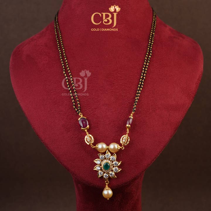 A one of a kind mangalsutra design featuring pearls and CZ's. 