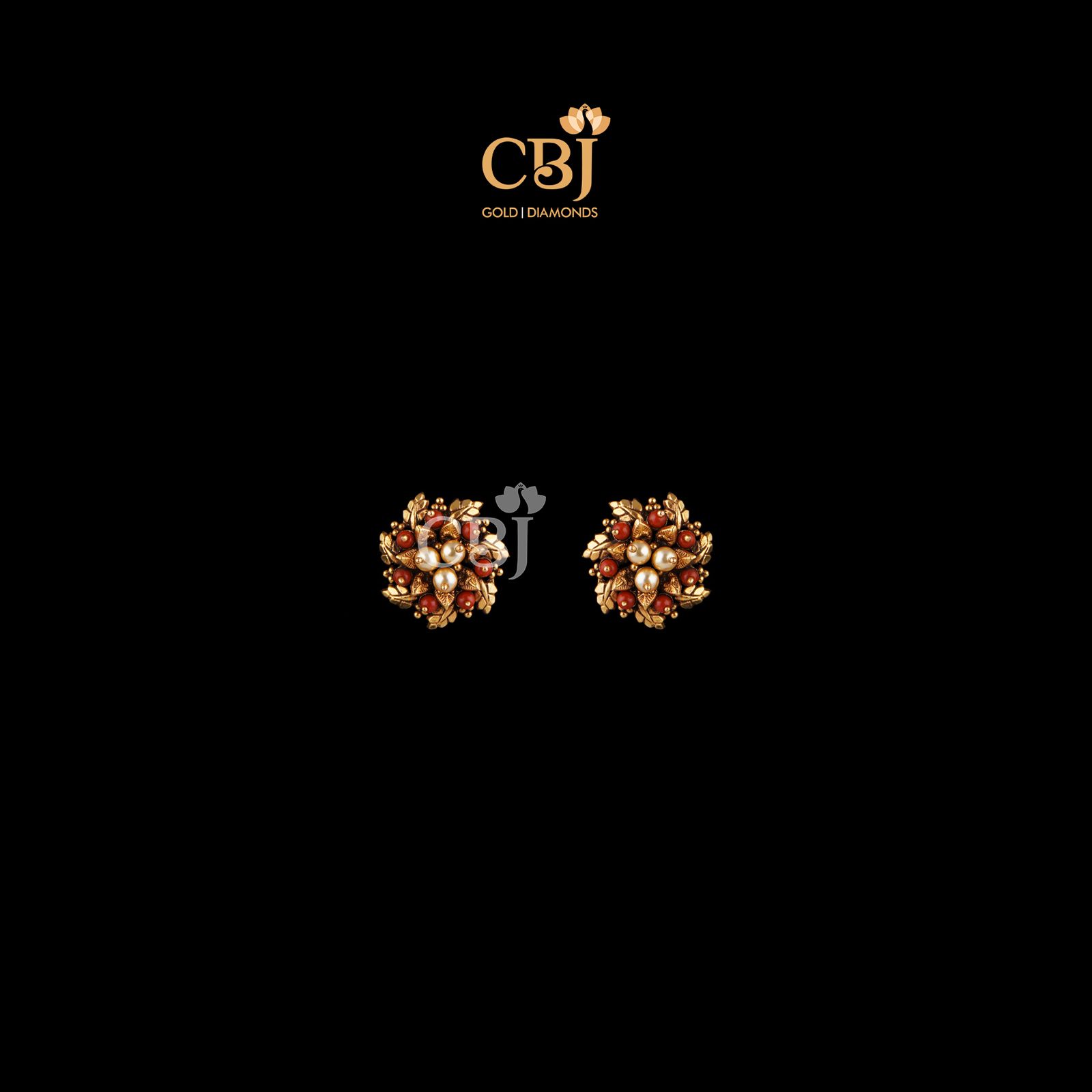 A floral design made out of coral stones. A stunning designer antique studs.