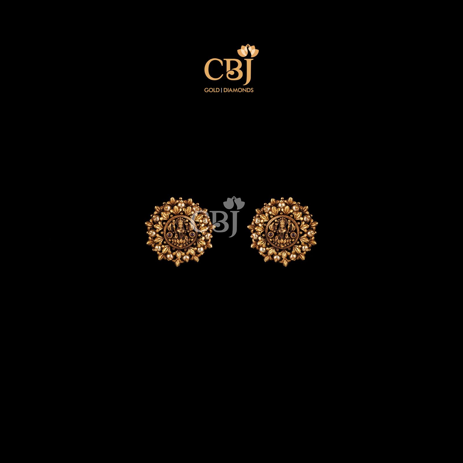 Antique studs featuring a Lakshmi design, studded with pearls.
