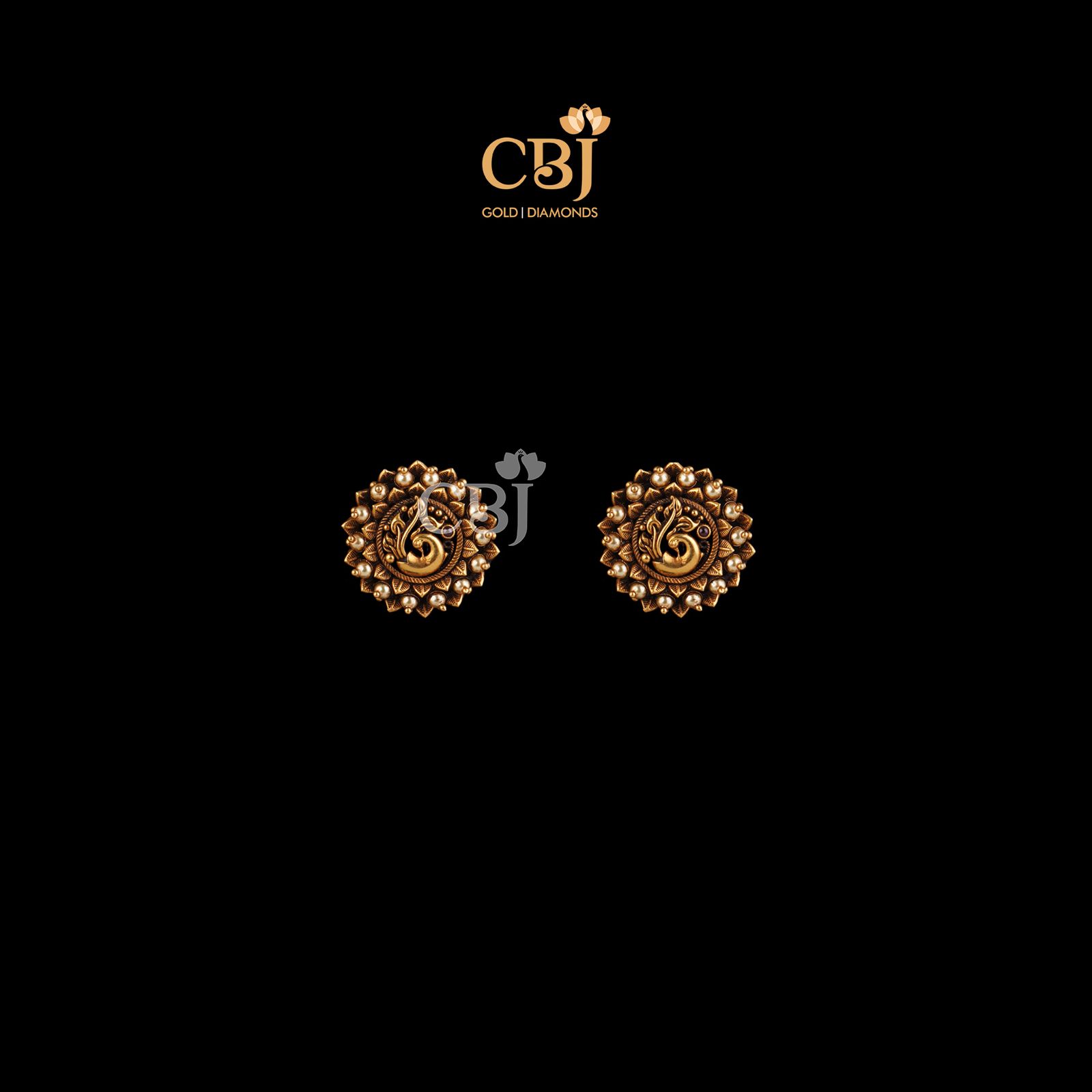 Antique studs featuring a peacock design, studded with pearls. 