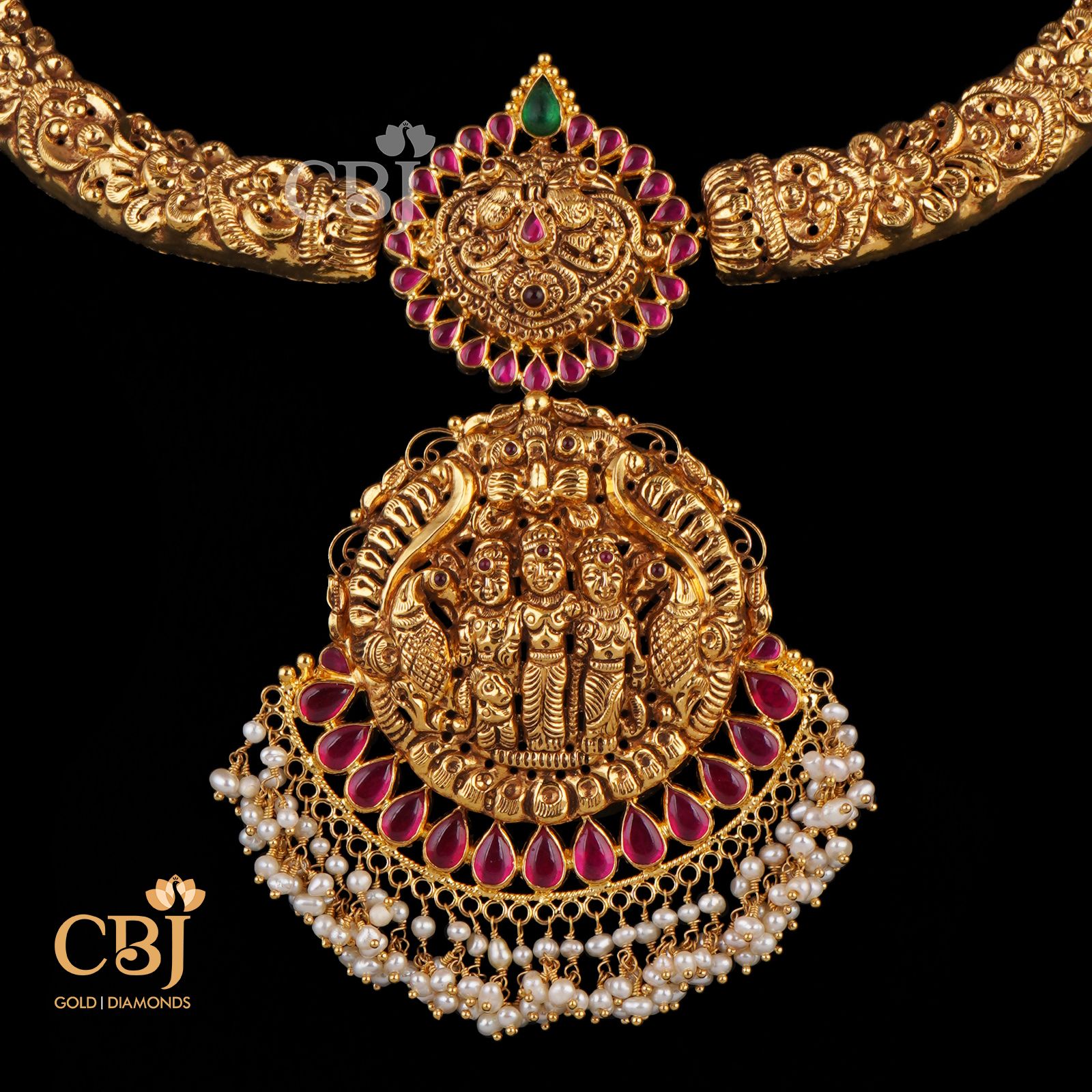 A unique designer Ramparivar necklace studded with rubies and suspended micro-pearls.