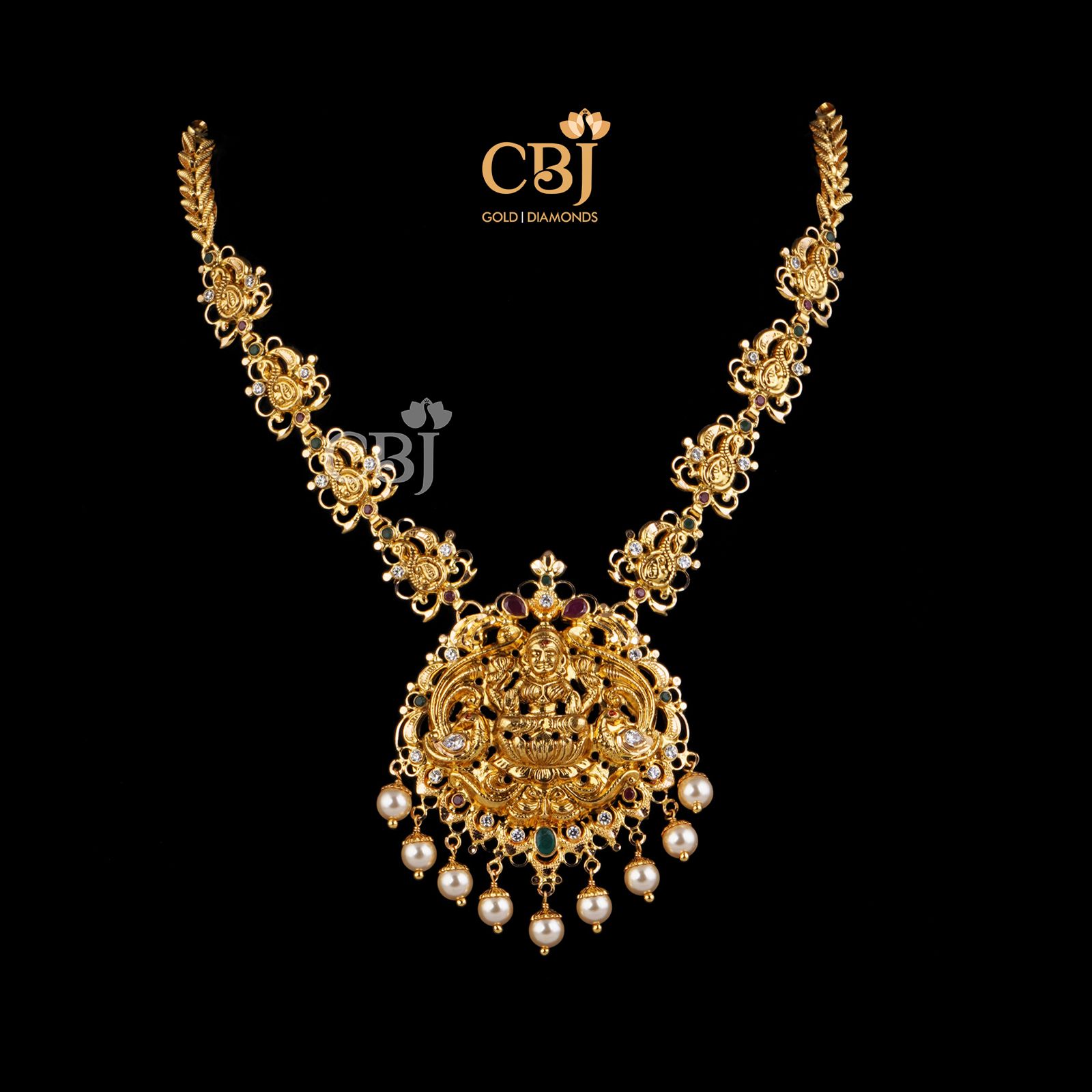 Sim, slender, sleek traditional design made from pure 22k gold. Studded with rubies, emeralds and pearls.