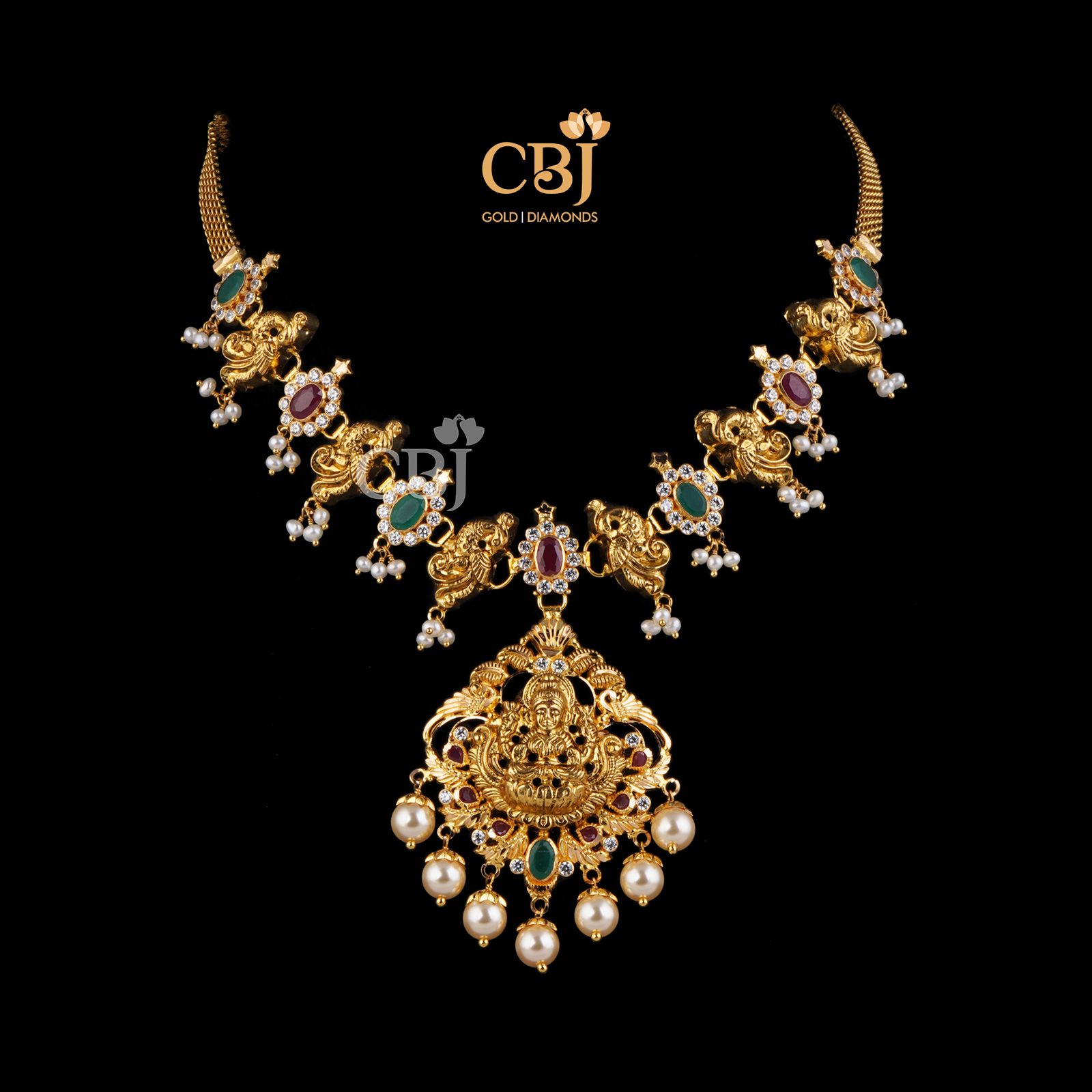 A short light weight necklace featuring rubies, emeralds and pearls.
