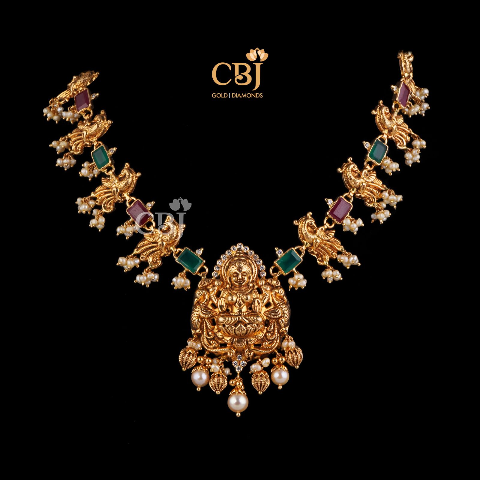 Pure 22k gold with rubies, emeralds and suspended micro pearls. A classic combination.