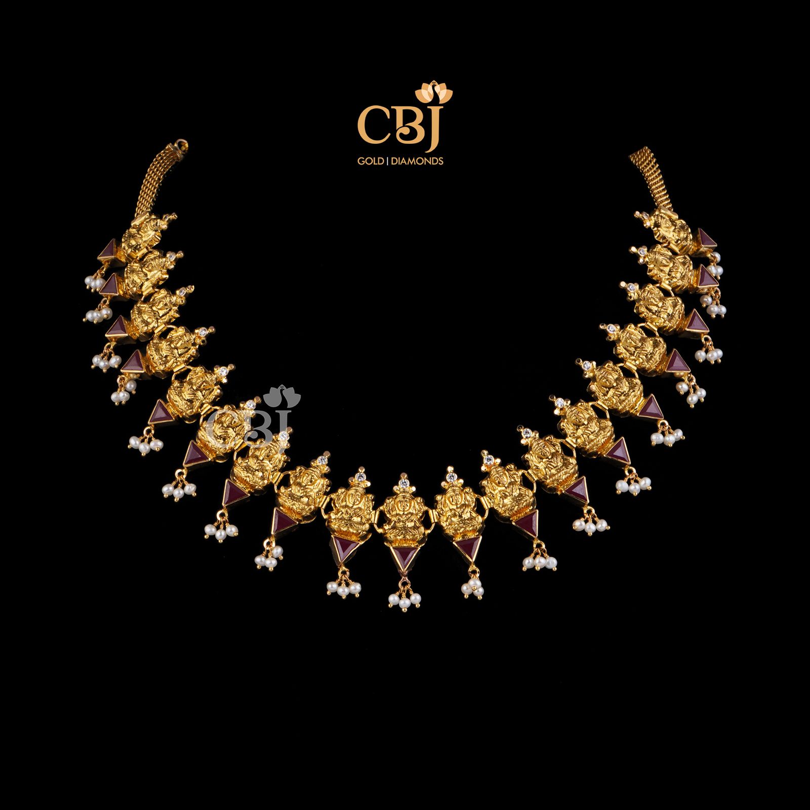 A divine design featuring Lakshmi motifs studded with ruby stones.