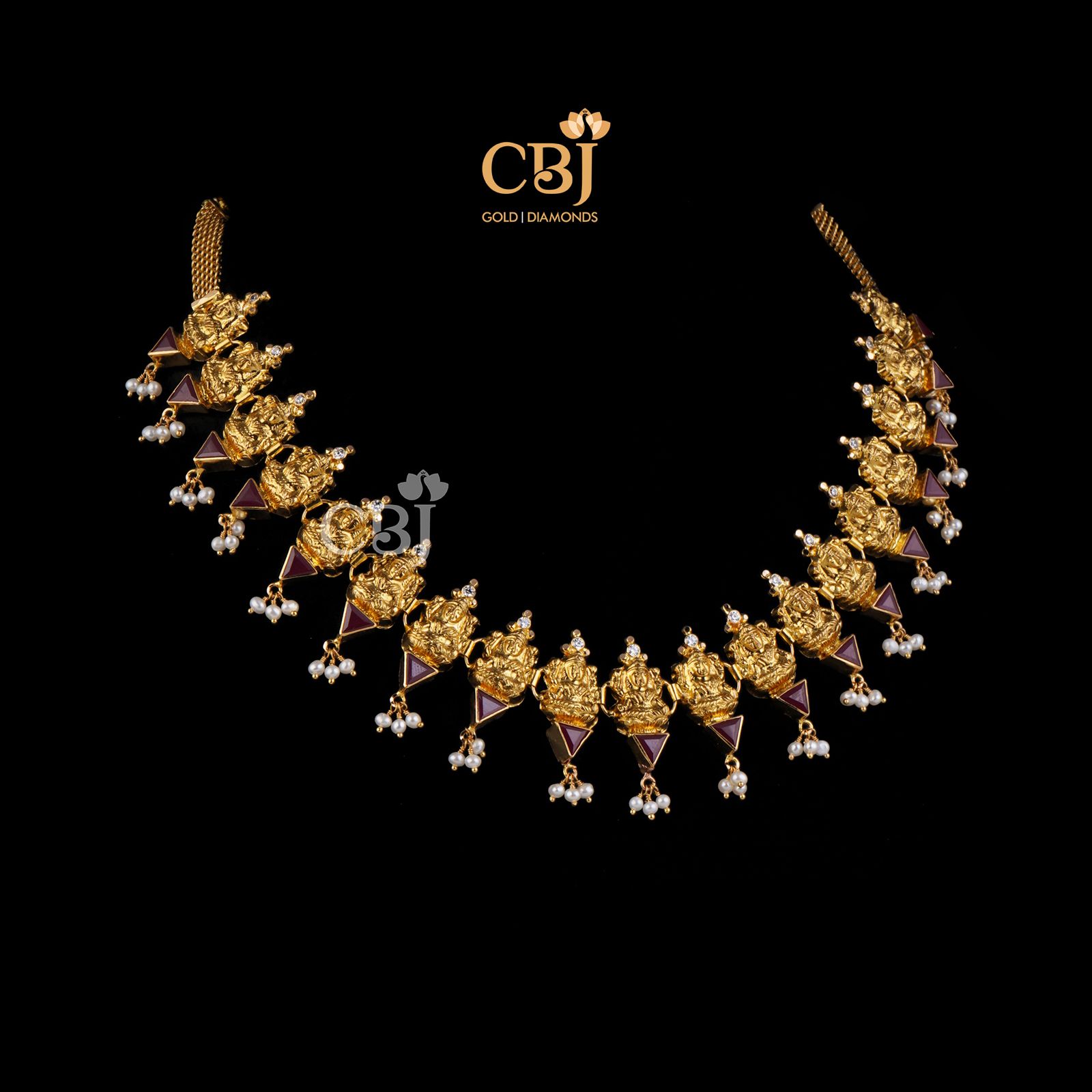 A divine design featuring Lakshmi motifs studded with ruby stones.