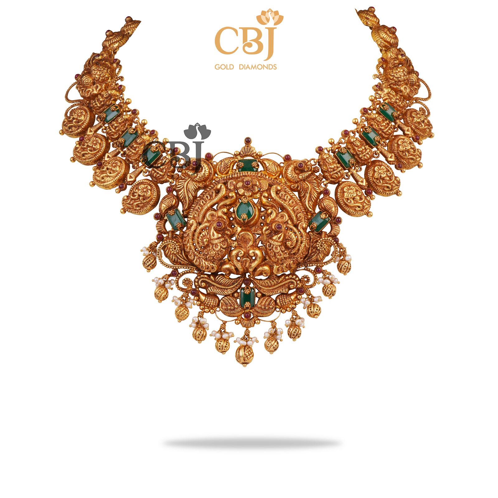 A bridal nakashi necklace with mango motifs studded with emerald stones.