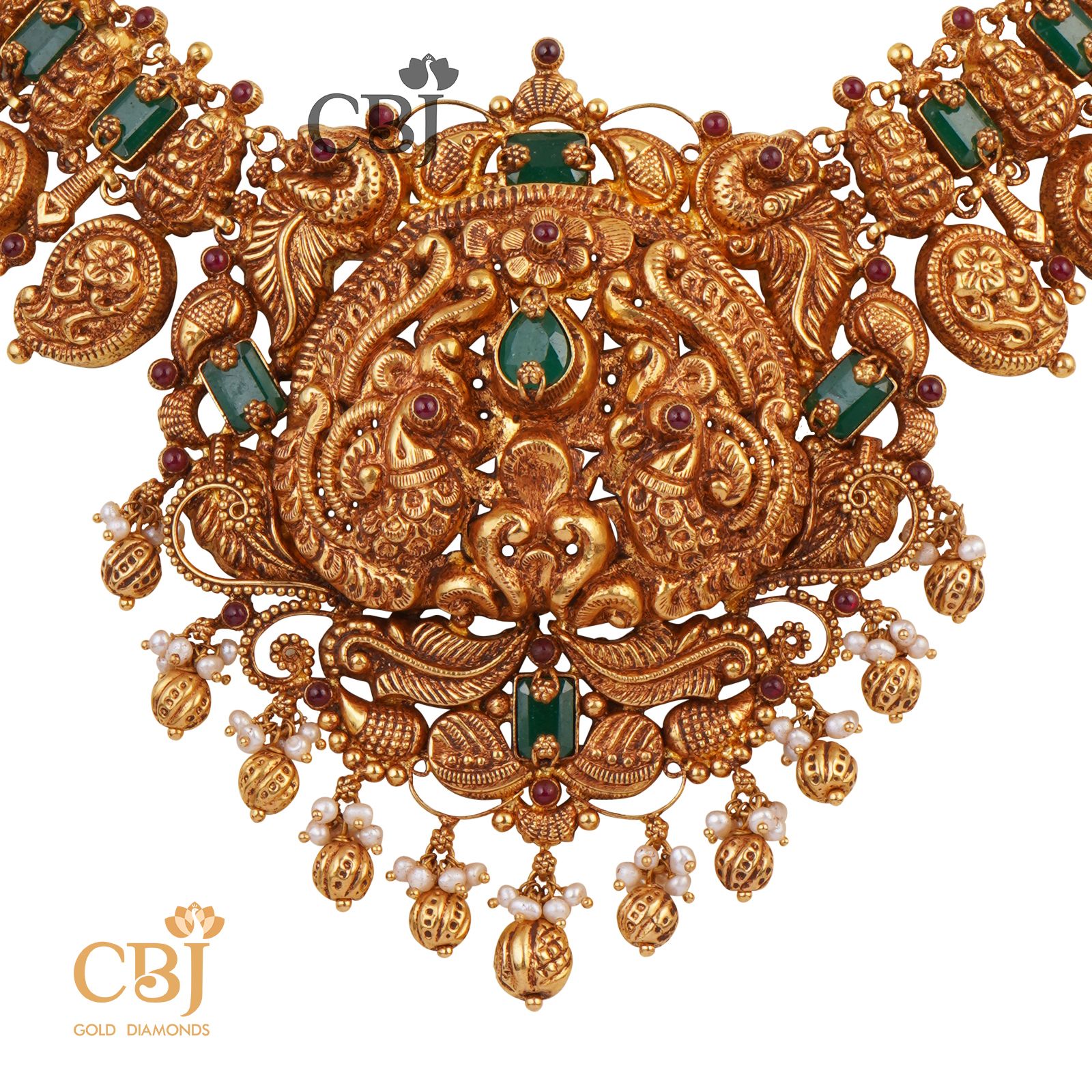 A bridal nakashi necklace with mango motifs studded with emerald stones.