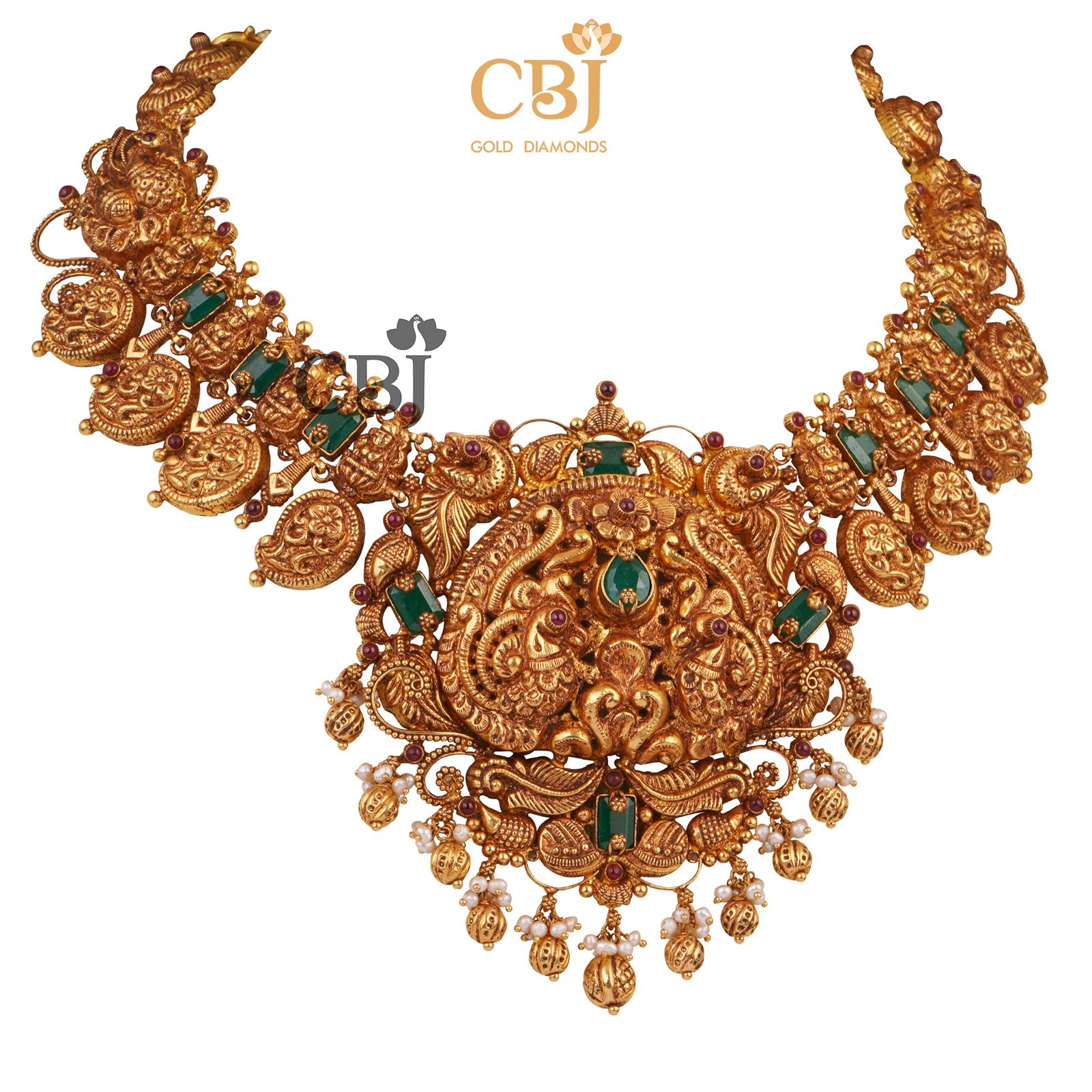 A bridal nakashi necklace with mango motifs studded with emerald stones.