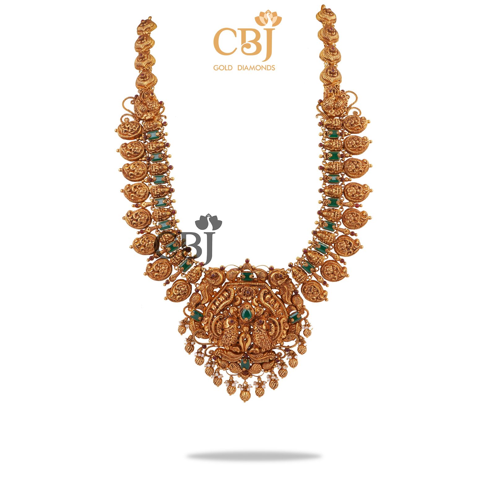 An antique mango U-Haram studded with emerald stones.
