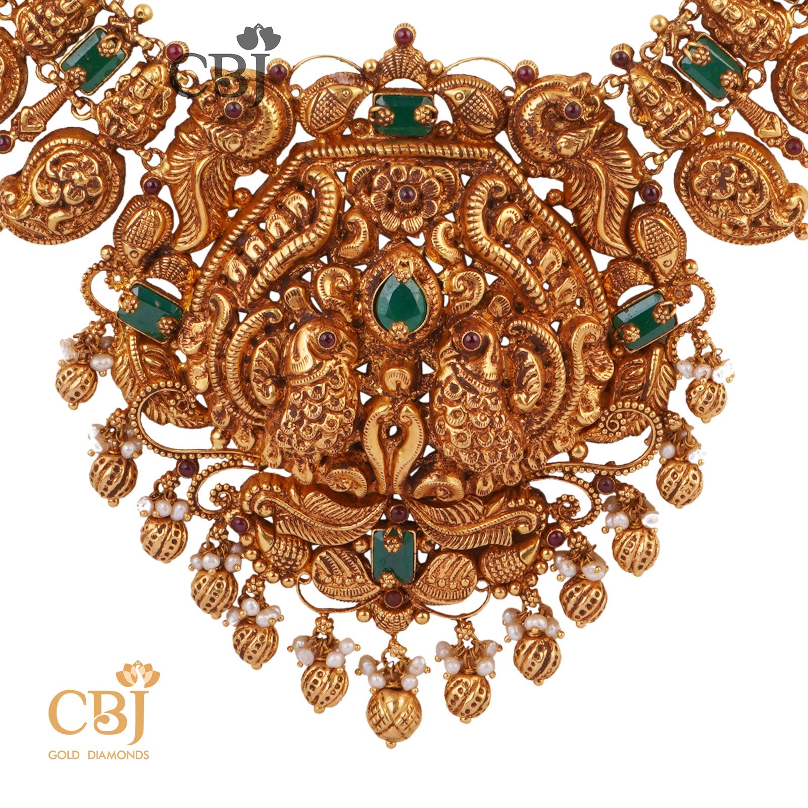 An antique mango U-Haram studded with emerald stones.