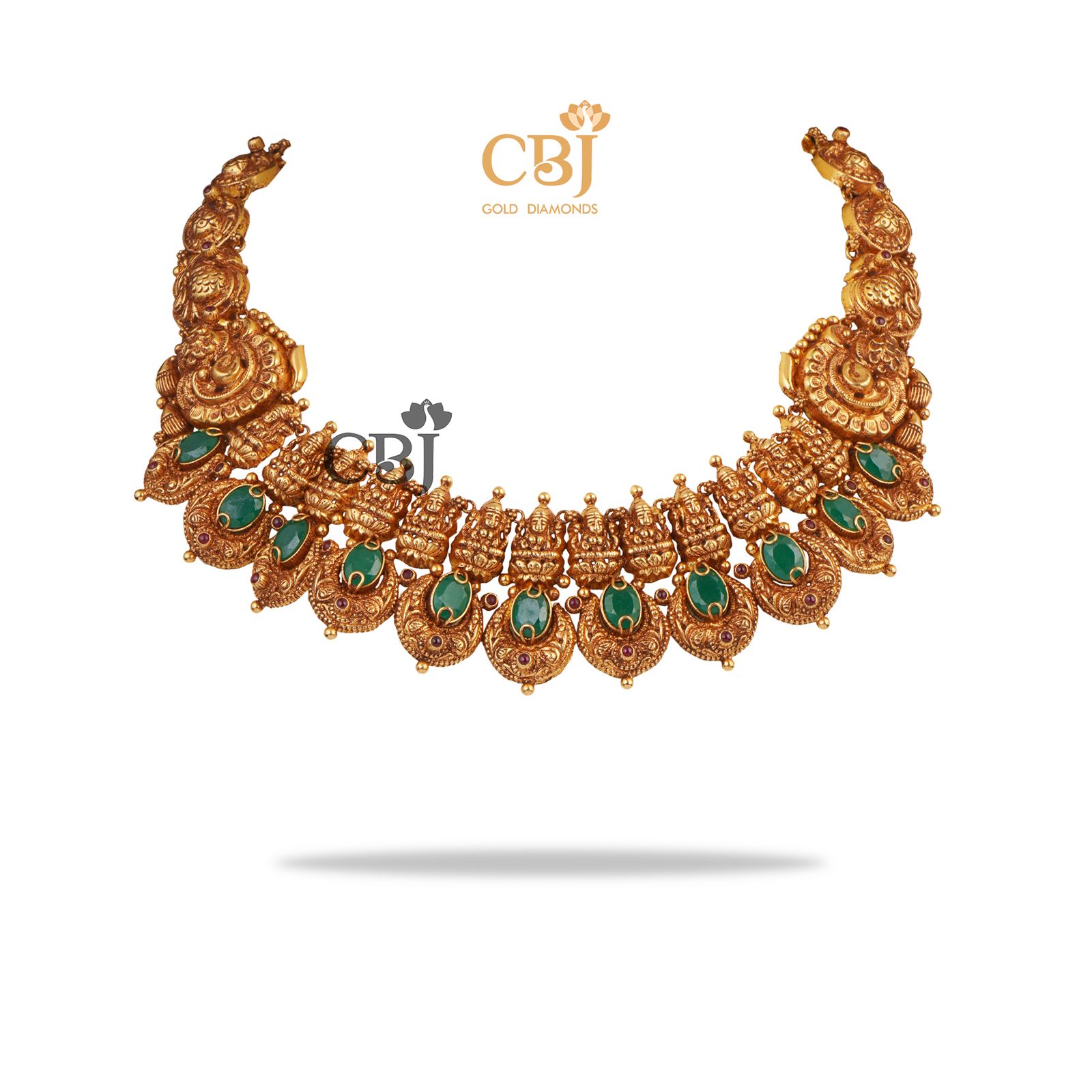 A short antique deep nakas haram studded with emerald stones.