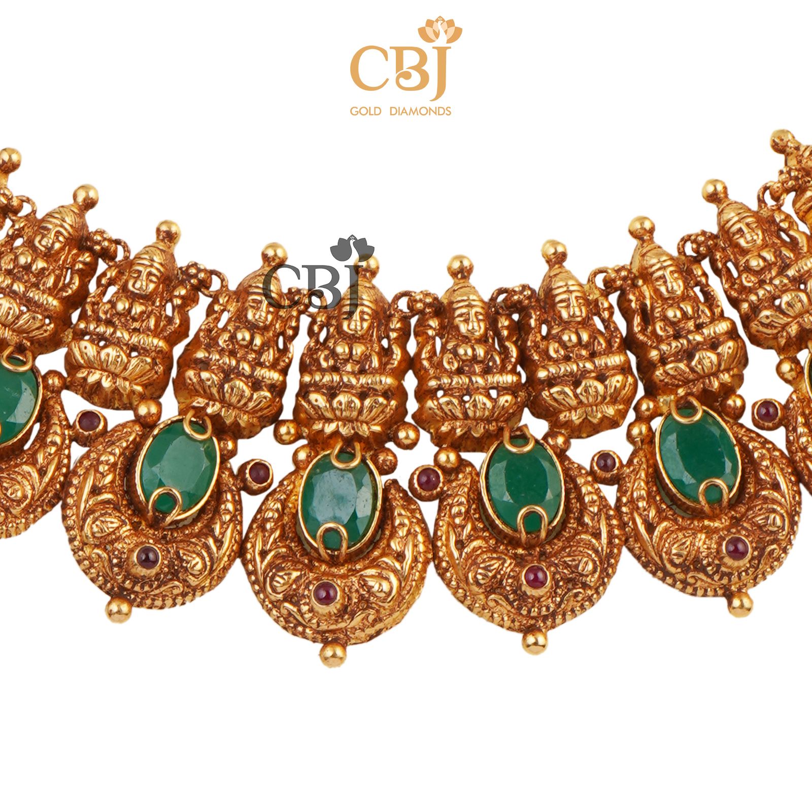 A short antique deep nakas haram studded with emerald stones.
