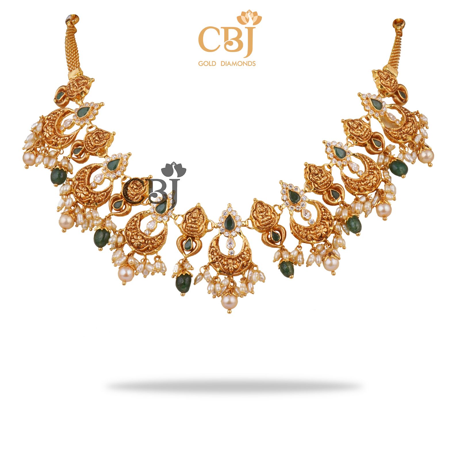 A light weight chand necklace featuring micro pearls and emerald drops.