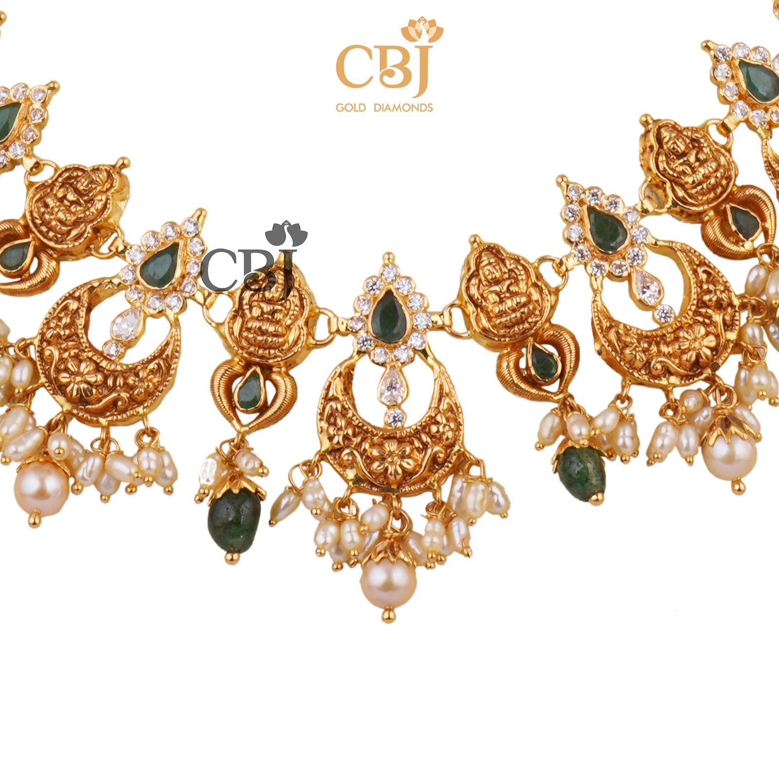 A light weight chand necklace featuring micro pearls and emerald drops.
